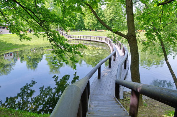 Vorontsov Park in Moscow, Russia. Wooden bridge over the pond