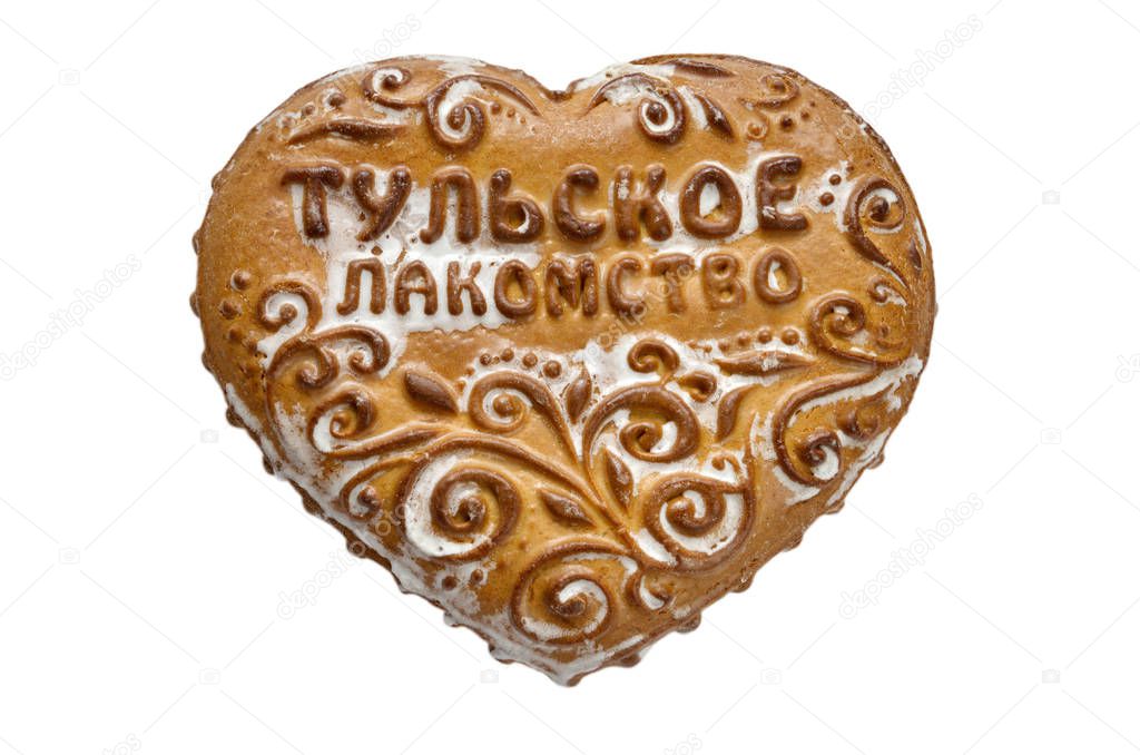 Souvenir Tula gingerbread in the form of a heart on a white background. On gingerbread the inscription 