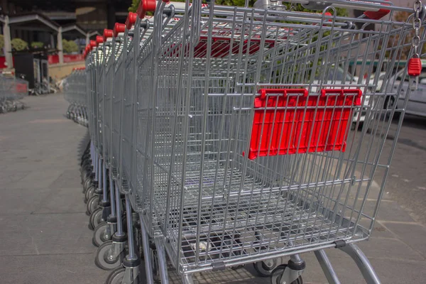 trolleys in the supermarket for products stand in a row of chrome silver color