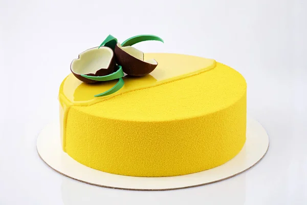 Yellow Tropical Mousse Cake Decorated Coconut Chocolate White Background Close — стоковое фото