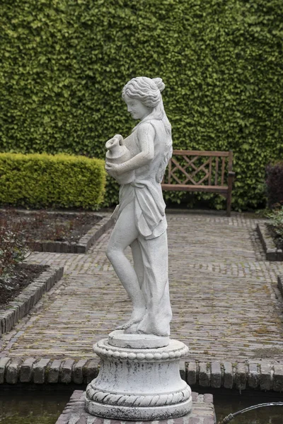 Medieval sensual female sculpture in the gardens of Castle of Arcen, Netherlands.