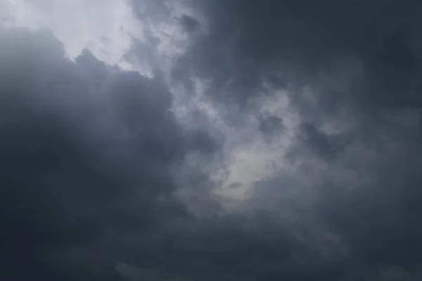 Dark thunder clouds on the blue sky. Abstract background with clouds on blue sky.