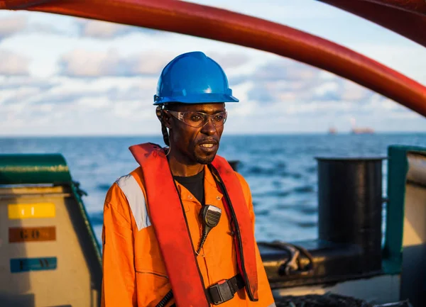 Seaman AB or Bosun on deck of vessel or ship , wearing PPE