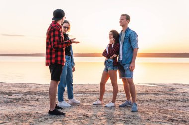 birlikte yürüyüş sırasında sunset beach üzerinde çift arkadaşlar