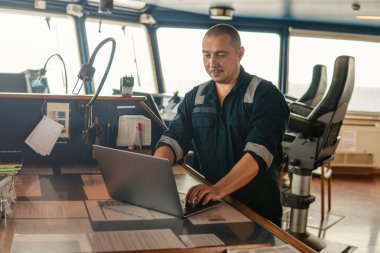 Deniz seyir subayı laptop ya da defter denizde kullanıyor