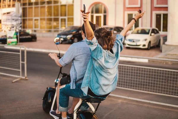 Lovely young couple driving electric bike during summer — Stock Photo, Image