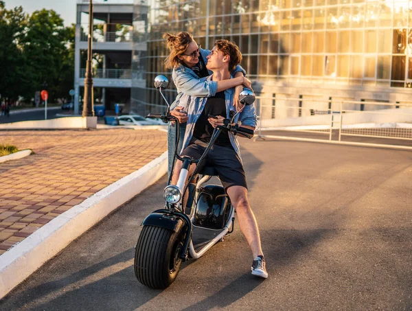 Lovely young couple dating with electric bike. — Stock Photo, Image