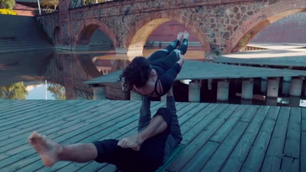 Beautiful couple practicing acro yoga in the morning — Stock Video