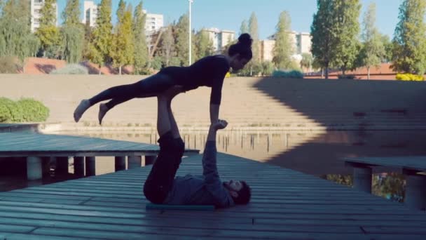 Beautiful couple practicing acro yoga in the morning — Stock Video