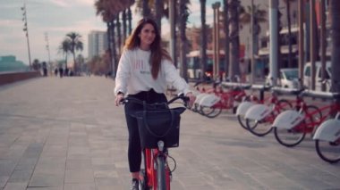 palmiye ağaçlarının yanında pedal genç kadın veya kız binicilik bisiklet