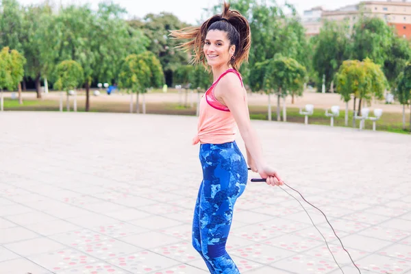 Ajuste hermosa mujer con saltar la cuerda en un parque —  Fotos de Stock