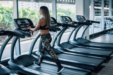 Genç kadının spor salonunda çalışan egzersiz yapması yerleştirmek