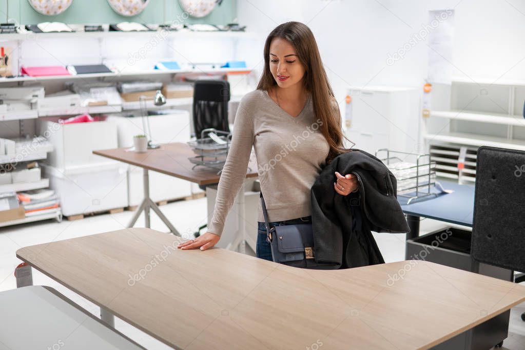 young beautiful woman finding herself new furniture, wooden table