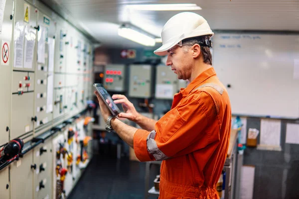 Mariene hoofdingenieur kijken naar digitale tablet in de controlekamer van de motor — Stockfoto