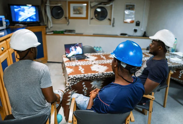 Seamen crew onboard a ship or vessel having fun watching movie