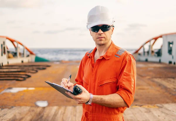 chief officer on deck of ship or vessel with checklist