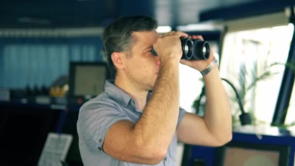 Officer during navigational watch looking through binoculars — Stock Video