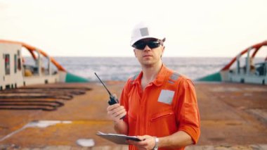 Güverte subayı offshore geminin güvertesinde Vhf telsiz telsiz tutar