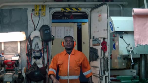 African marine engineer officer in engine control room ECR. — Stock Video