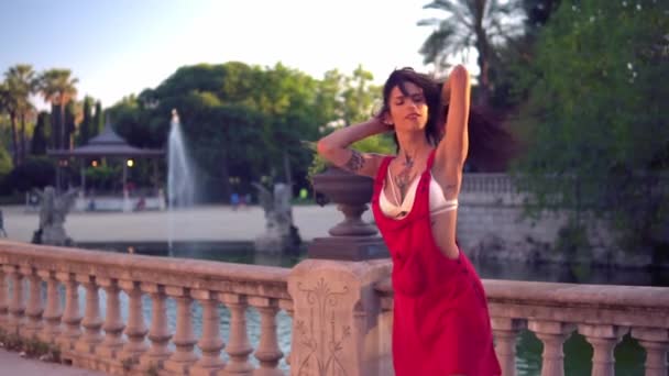 Ladyboy tattooed transgender model is dancing in the green park — Stock Video