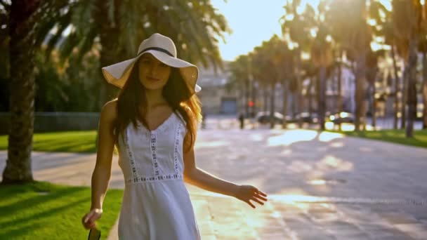 Bella donna vestita di bianco e cappello di pamela a piedi — Video Stock