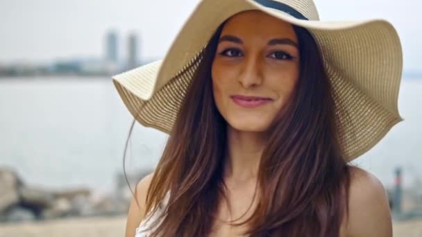 Pretty woman wearing white dress and pamela hat walking — Stock Video