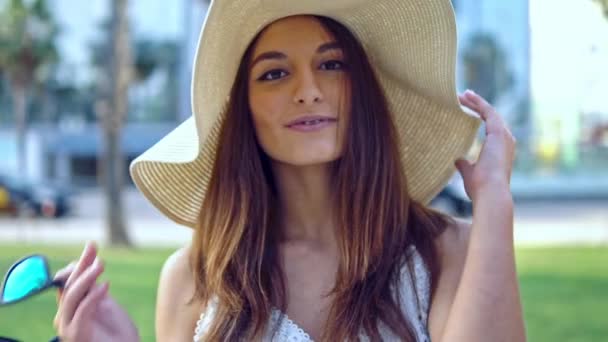 Pretty woman wearing white dress and pamela hat walking — Stock Video