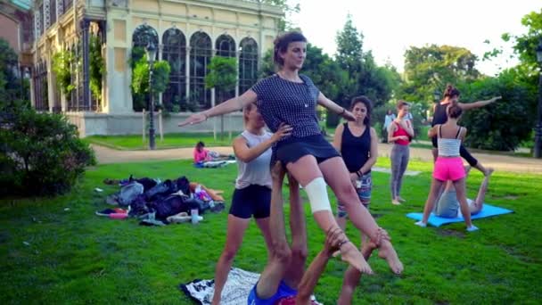 Skupinová lekce o akroyoga, která se odehrává v parku — Stock video