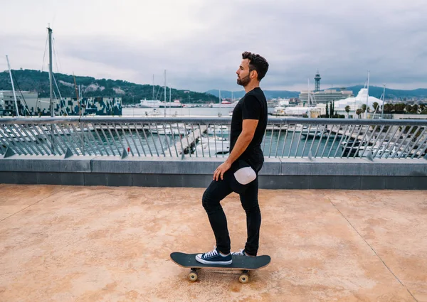 Skateboarder monta un monopatín en la moderna terraza de la ciudad . —  Fotos de Stock