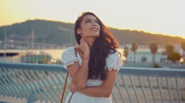Deniz gezinti boyunca yürüyen beyaz elbiseli güzel kız