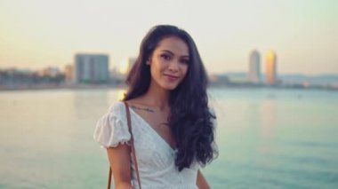 Deniz gezinti boyunca yürüyen beyaz elbiseli güzel kız