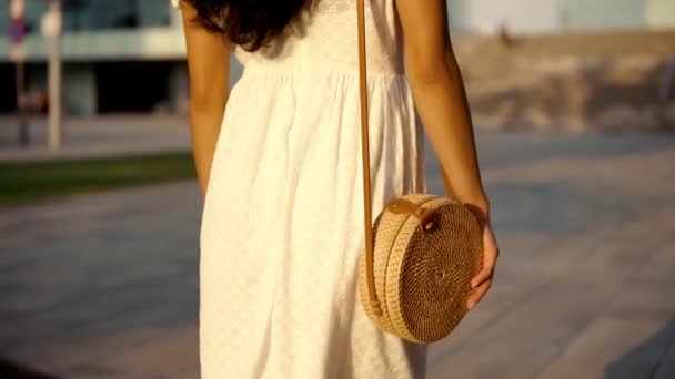 Primo piano di una ragazza in abito bianco con borsa da donna . — Video Stock