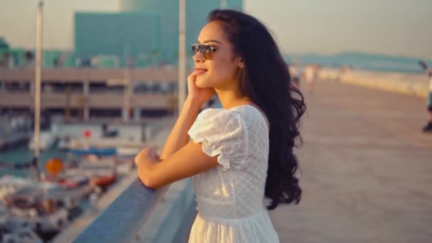 Chica en el vestido blanco de pie en la terraza del paseo marítimo — Vídeos de Stock