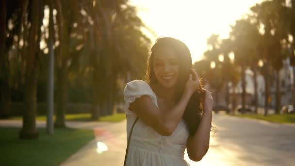 Chica en el vestido blanco caminando por la terraza de la palmera — Vídeo de stock