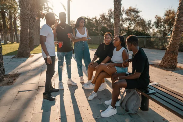 Grupo de jóvenes amigos negros africanos modernos felizmente sentados juntos — Foto de Stock