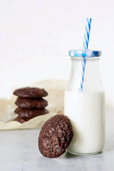 Runde Gebackene Schokoladenkekse Und Eine Flasche Milch Auf Hellem Hintergrund — Stockfoto