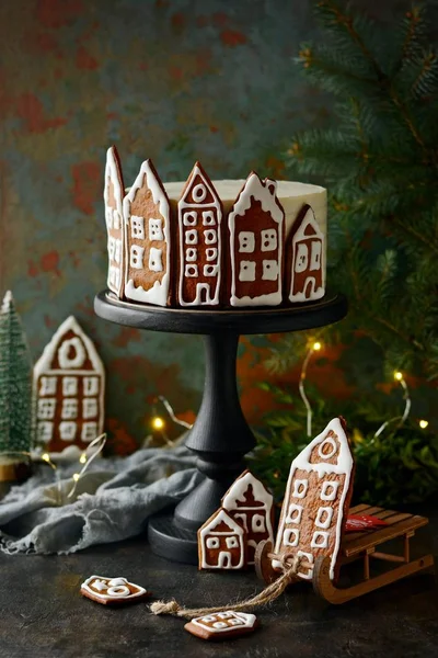 Homemade honey cake with sour cream, decorated with gingerbread. Rustic style. Christmas decor, atmosphere, winter background