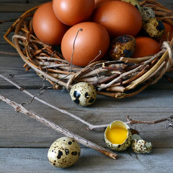 Colored Easter eggs in a wicker basket on rustic wooden background, concept of Easter holiday, selective focus. Happy easter. Easter decoration, copy space