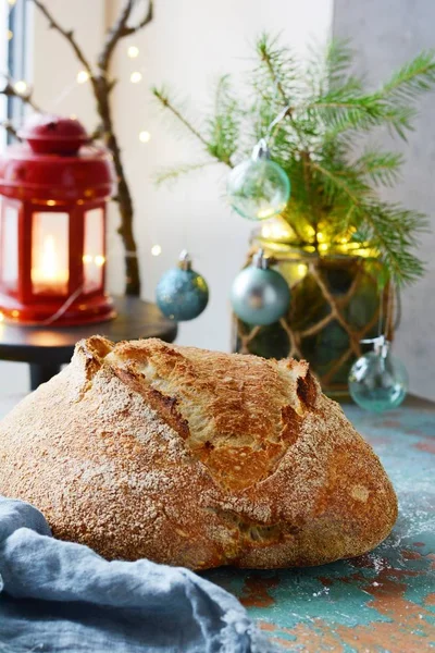 Fresh homemade bread on a gray-blue background, on whole wheat flour. French bread round shape. Bread baking. Unleavened bread. Christmas and New Year