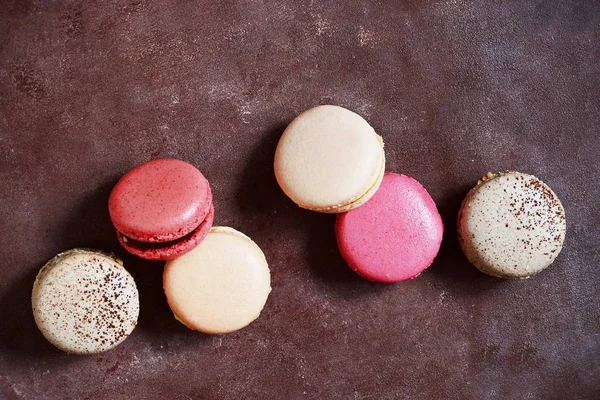 French assorted macarons cakes on a rectangular dish on a gray background. Colorful Small French cakes. Top View.