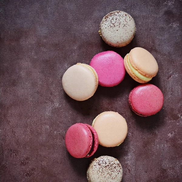 French assorted macarons cakes on a rectangular dish on a gray background. Colorful Small French cakes. Top View.