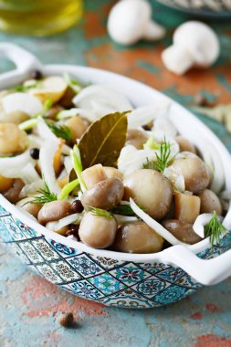 Soğan, biber, dereotu ve gri-mavi zemin üzerine zeytin yağı ile güzel bir kase lezzetli Marine mantar görünümü, petrol top