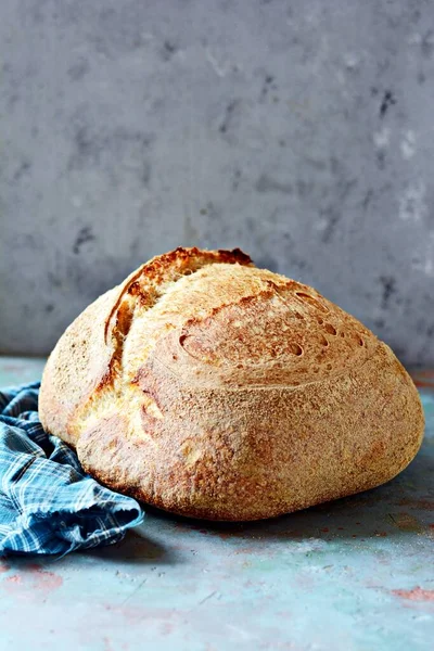 Homemade Freshly Baked Country Bread  made from wheat and whole grain flour on a gray background. French Freshly baked bread.