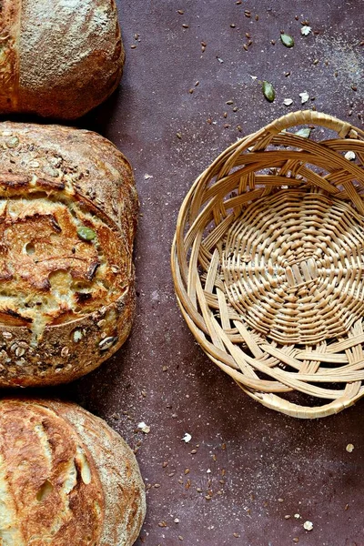 Homemade Freshly Baked Country Bread  made from wheat and whole grain flour on brown background. French Freshly baked bread.