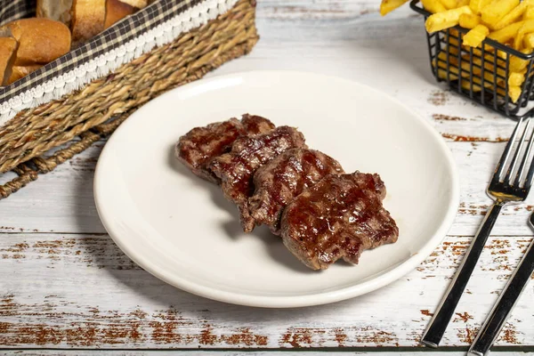 Freshly grilled beef tenderloin slices. Slices of cooked tenderloin on wood background. high quality photo