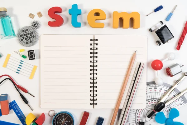 STEM Education. Science Technology Engineering Mathematics. STEM word on book with education equipments for background.