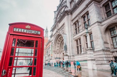 Brighton, İngiltere-18 Ekim 2018: Kensington Londra, İngiltere 'de öğrencilerle ve turistlerle klasik kırmızı telefon Londra kutusuyla Victoria ve Albert Müzesi cephesine giriş.