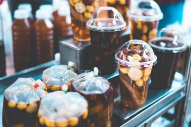 Tayland 'da Sweet Taothueng olarak bilinen Asya' daki sokak yemekleri dükkanında plastik bir fincan ve plastik poşet dolusu soğuk fasulye, nilüfer kökü, ginkgo, longan ve tatlı şurup..