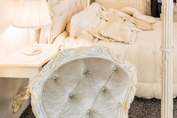 Close up photo classic royal white bedroom  with selective focus on luxury chair