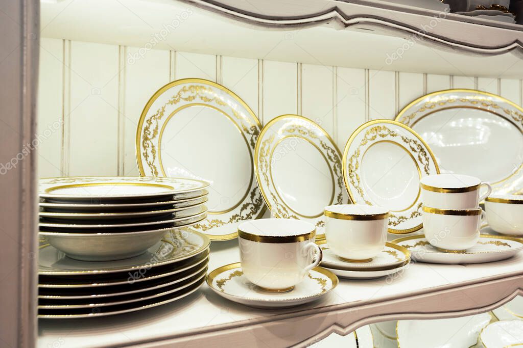 Beautiful elegant white tableware set with golden pattern